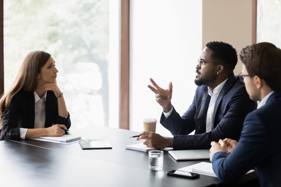 three co-works use effective communication during a meeting