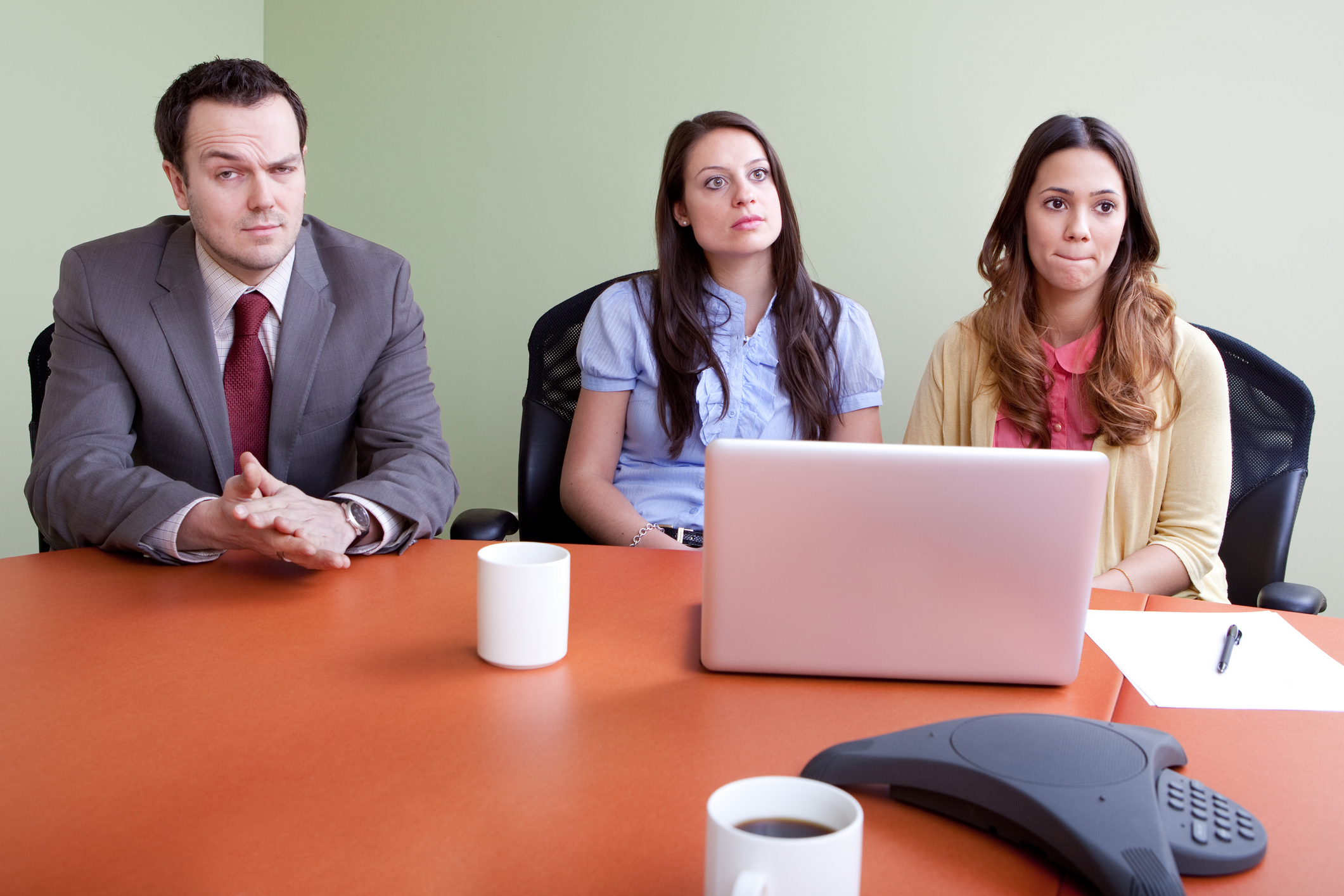 A business man and two women sitting in a presentation