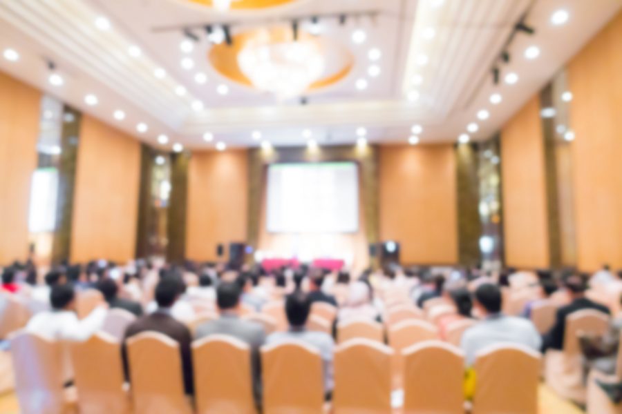 blurry image of business Conference Speaker