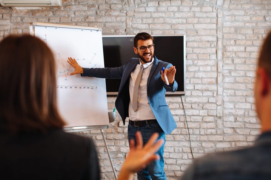 Business man using a presentation persona during a meeting.