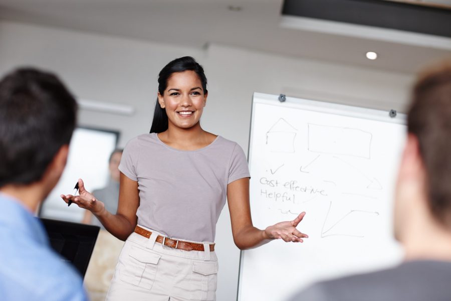 A young businesswoman facilitating a budget meeting in the boardroom