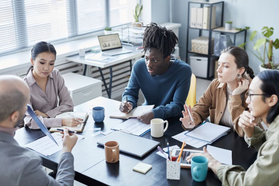 People in a meeting taking notes